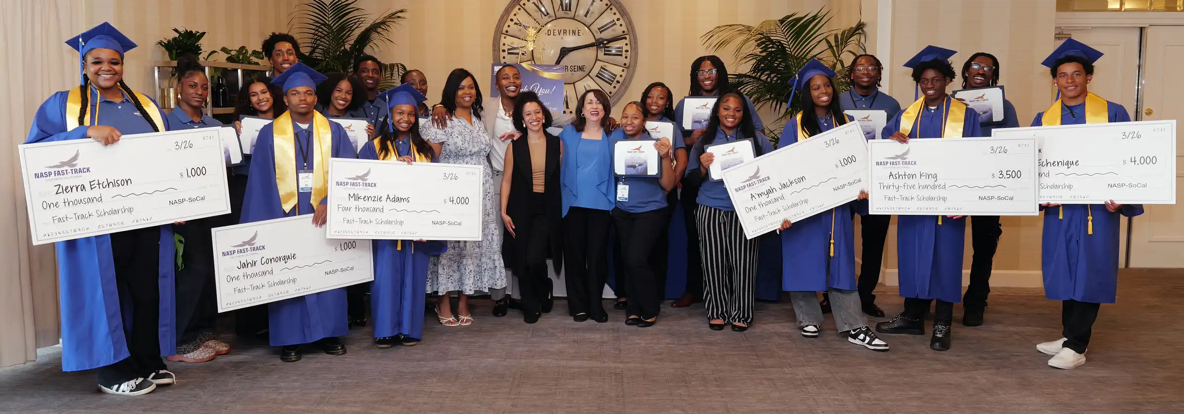 Fast-Track Students with oversized checks.